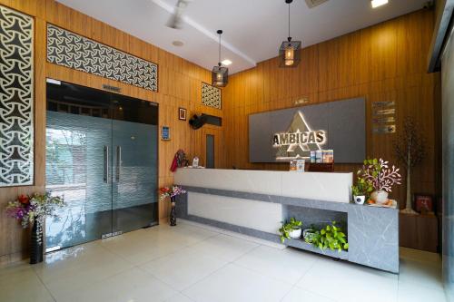 a lobby of aazaolis with a sign on the wall at Open Hotel by Olive - Ambicas Grand in Visakhapatnam