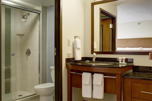 a bathroom with a sink and a toilet and a mirror at Hyatt Place Dublin/Pleasanton in Dublin