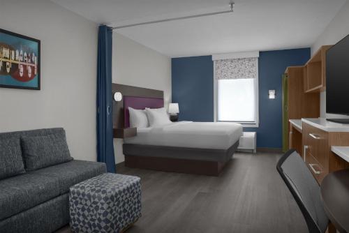a hotel room with a bed and a couch at Home2 Suites by Hilton Florida City in Florida City