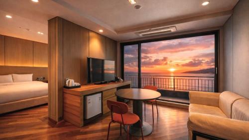 a hotel room with a bed and a large window at Incheon Grace Hotel in Incheon