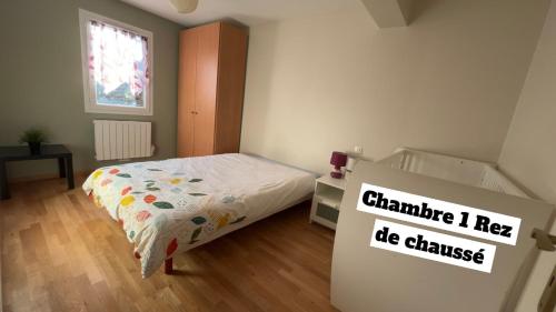 a bedroom with a bed and a sign that reads chaminate i need be at Maison Grebert in Gouffern en Auge