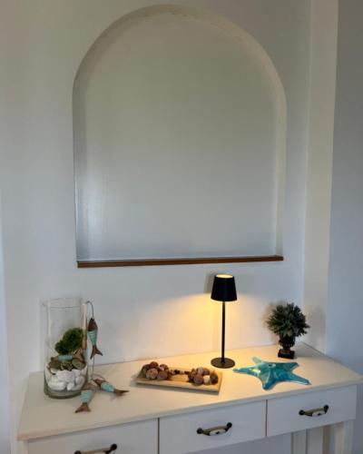 a white cabinet with a lamp on top of it at Myrto Signature Suite - Aegina in Aegenitissa