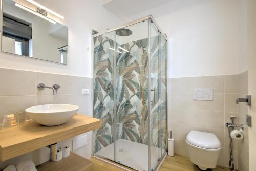 a bathroom with a glass shower and a sink at Guest House al porto in Civitavecchia