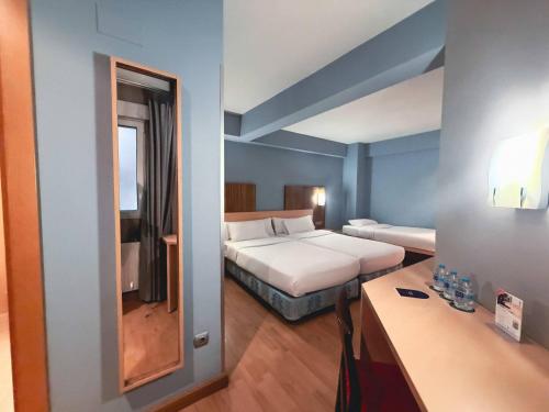 a hotel room with a bed and a mirror at Hotel Faranda Alisas Santander, Ascend Hotel Collection in Santander
