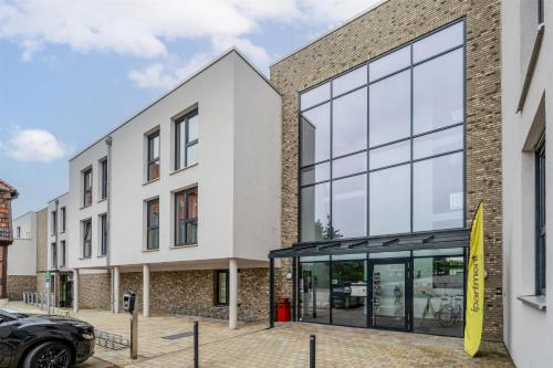 an office building with a large glass facade at ipartment Wolfsburg HOME by Best Western in Wolfsburg