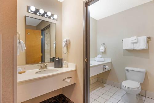 a bathroom with a toilet and a sink and a mirror at Newport Oceanfront Inn in Newport