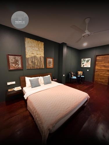 a bedroom with a large bed in a room at Tropical Garden House in Siem Reap