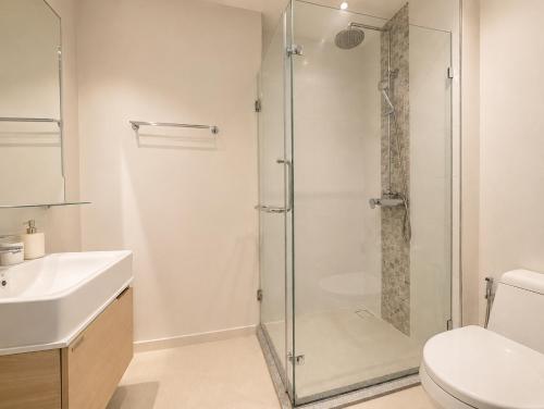 a bathroom with a shower and a toilet and a sink at Pool View 1 BR Apt for 3 - Diamond Condo 5209 in Bang Tao Beach