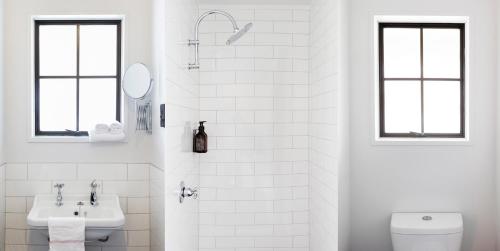 a white bathroom with a sink and a toilet at Sherwood in Queenstown