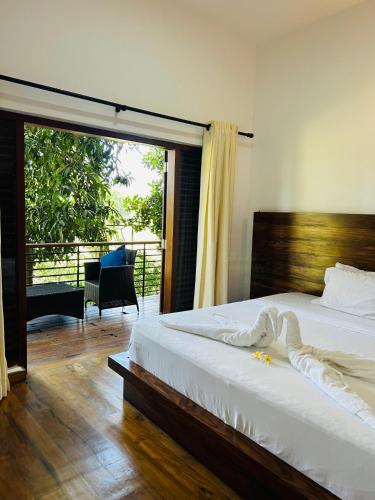 a bedroom with a bed and a sliding glass door at 47 - Your Ultimate Relaxation in Colombo in Pannipitiya