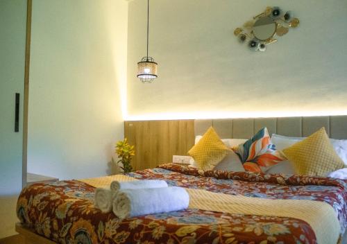 a bedroom with a large bed with towels on it at Oshana Stays,Fully furnished Studio Apartment with Pool,Sauna,Siolim, Goa in Mapusa
