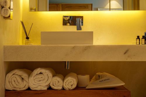 a shelf with rolls of towels in a bathroom at Warehouse By The Stay in Alaçatı