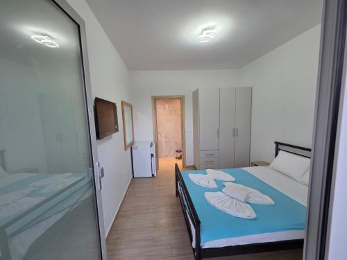 a bedroom with two beds and a sliding glass door at VasilikiApartments in Vasiliki