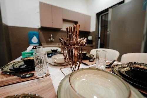 a table with plates and glasses on top of it at Woods Luxury Villas in Lonavala