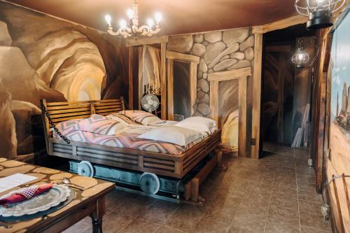a bedroom with a large bed in a room with a painting at Guest house Western-city in Chaudfontaine