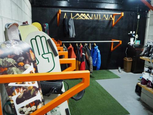 a room with a rack of clothes in a store at Hotel Villa Hakuba by HHG in Hakuba