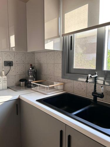 a kitchen with a sink and a window at Luxury casa in Nea Makri