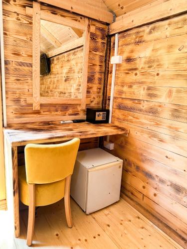 a desk and a chair in a room with wooden walls at Rafting centar RT in Foča