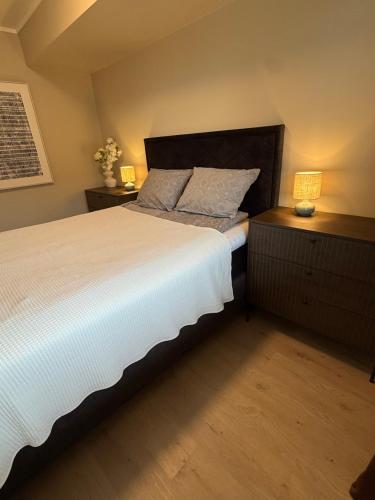 a bedroom with a large bed and two night stands at Experience Senja in Senja