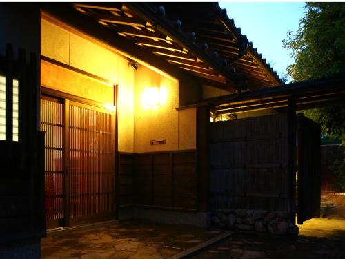 a house with a light on the side of it at 縁の宿 北堀 in Matsue