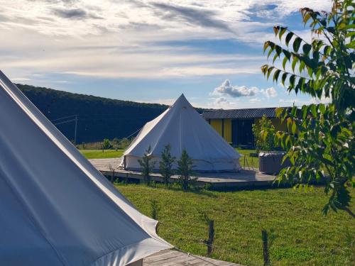 a large white tent in a field next to a building at ILLU Glamping in Trebujeni