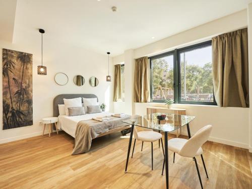 a bedroom with a bed and a glass table at Catalina Retiro Madrid in Madrid