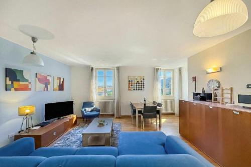 a living room with a blue couch and a table at La Piazza Menaggio in Menaggio