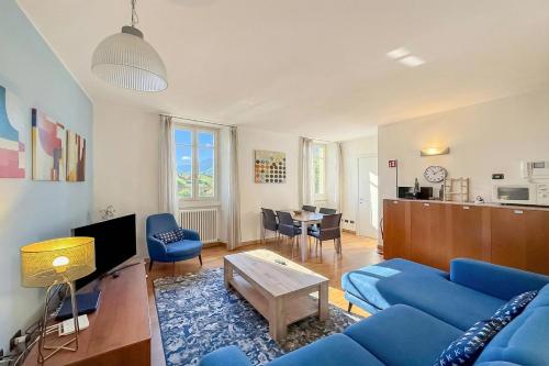 a living room with a blue couch and a table at La Piazza Menaggio in Menaggio