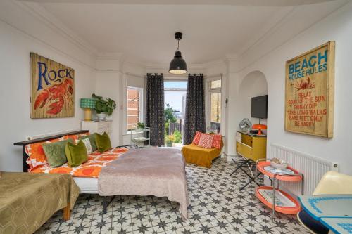 a bedroom with a bed and a living room at Enjoy Sandown 1 in Sandown