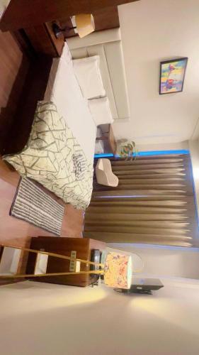 a view of a bedroom with a bed and a skateboard at Skycabinomaxe in Greater Noida
