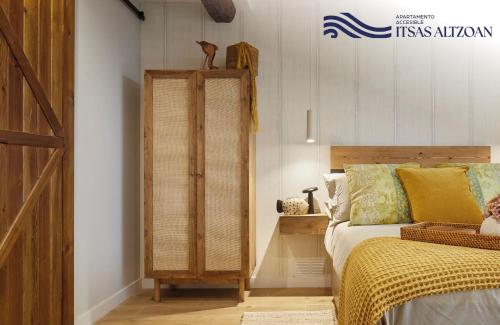 a bedroom with a bed and a wooden door at ALTZOAN Apartamentos Turísticos y aparcamiento gratuito in Zarautz