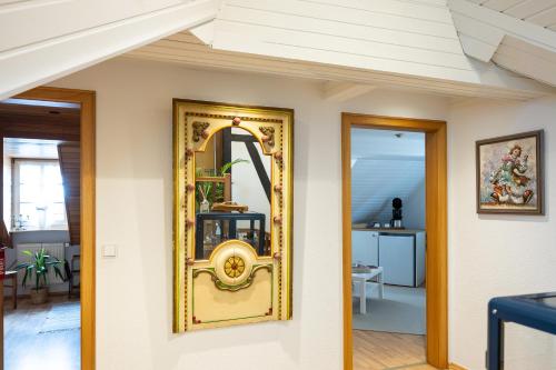 a room with a gold mirror on a wall at Zum Alten Turm in Hennef