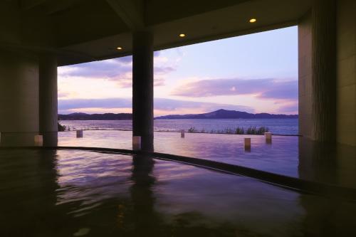 a swimming pool with a view of the water at TAOYA Shima in Toba
