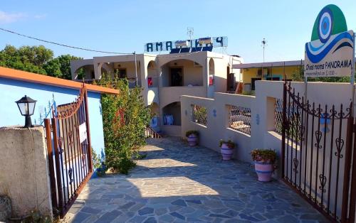 a building with a gate and some potted plants at Chios Panorama in Karfas
