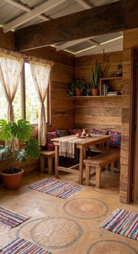 a room with a table and benches in a room at Paxel Forest in San Lorenzo El Cubo