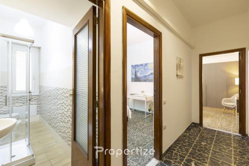a bathroom with a sink and a mirror at Central Cagliari by Propertize in Cagliari