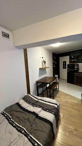 a bedroom with a bed and a table in it at Parenzana Apartment in Portorož