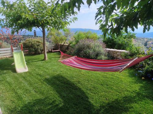 a hammock in the grass in a garden at ''Shinohori'' Olive-Tree Apartment in Argos