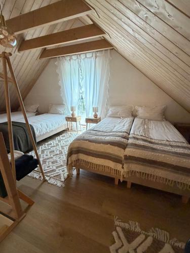 a bedroom with two beds in a attic at Radawa LOVE in Radawa