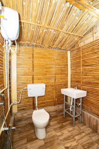 a bathroom with a toilet and a sink at Padmabati Park in Balasore