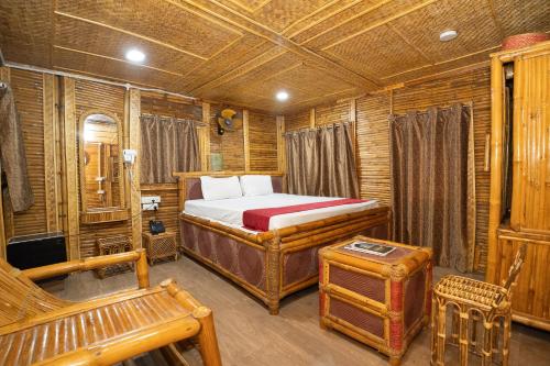 a bedroom with a bed in a wooden room at Padmabati Park in Balasore
