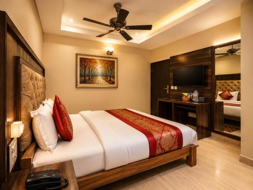 a bedroom with a large bed and a television at Hotel Atlanta Continental, Paharganj New Delhi in New Delhi