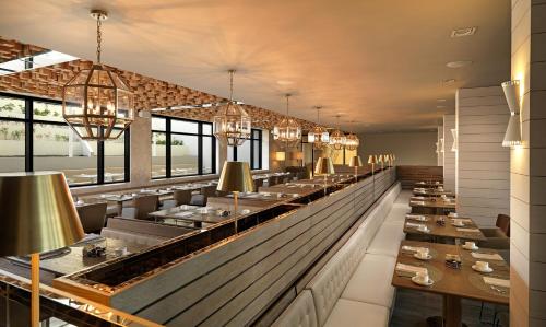a restaurant with long tables and chandeliers at Paradisus Los Cabos - Adults Only - All Inclusive in Cabo San Lucas