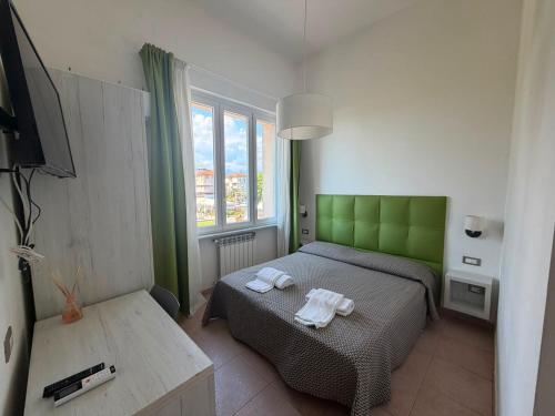 a bedroom with a bed with two towels on it at Hotel Nuovo Tirreno in Lido di Camaiore