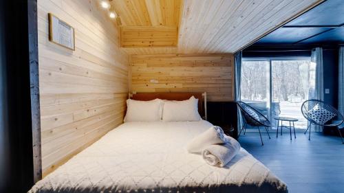 a bedroom with a bed in a room with wooden walls at Peak Pine by AvantStay in Albrightsville