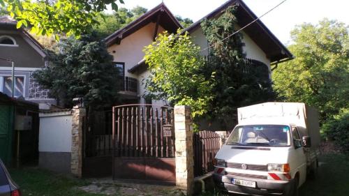 a white truck parked in front of a house at Spacious chalet in Sibiel with mountain and lake views + Jacuzzi in Sibiel