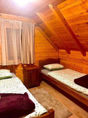 a bedroom with two beds in a cabin at Vikendica Veruša in Veruša