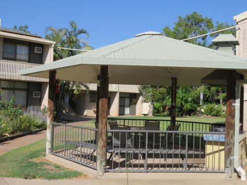 a gazebo with a table and chairs under it at Emerald Gardens Motel & Apartments in Emerald