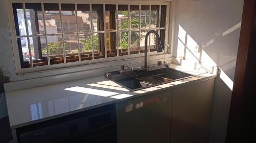 a kitchen with a sink and a window at Pati place in Mememo