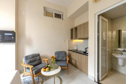 a small living room with two chairs and a table at G8 Le Van Sy Hotel Saigon in Ho Chi Minh City